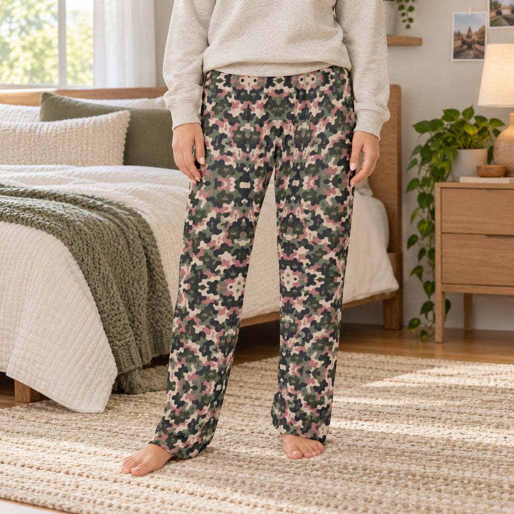Lifestyle photo: Kingdom Camo faith-based all-over-print pajama pants in a cozy bedroom setting.