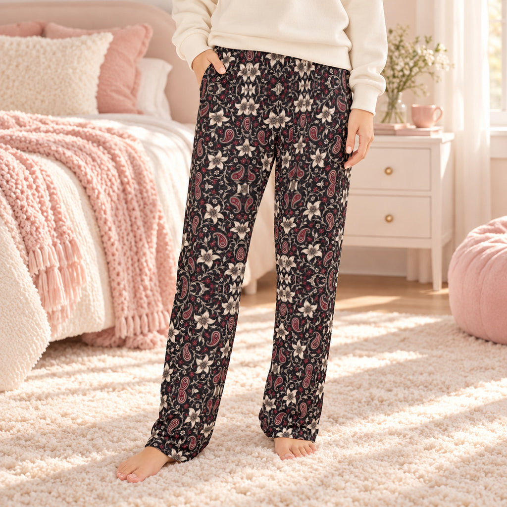 Lifestyle photo: Lily and Thorn Bandana faith-based all-over-print pajama pants in a cozy bedroom setting.