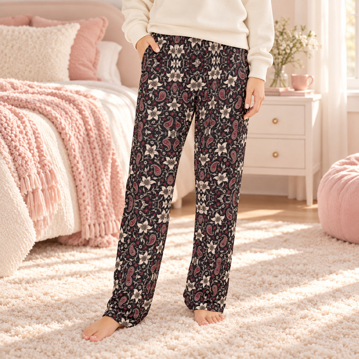 Lifestyle photo: Lily and Thorn Bandana faith-based all-over-print pajama pants in a cozy bedroom setting.